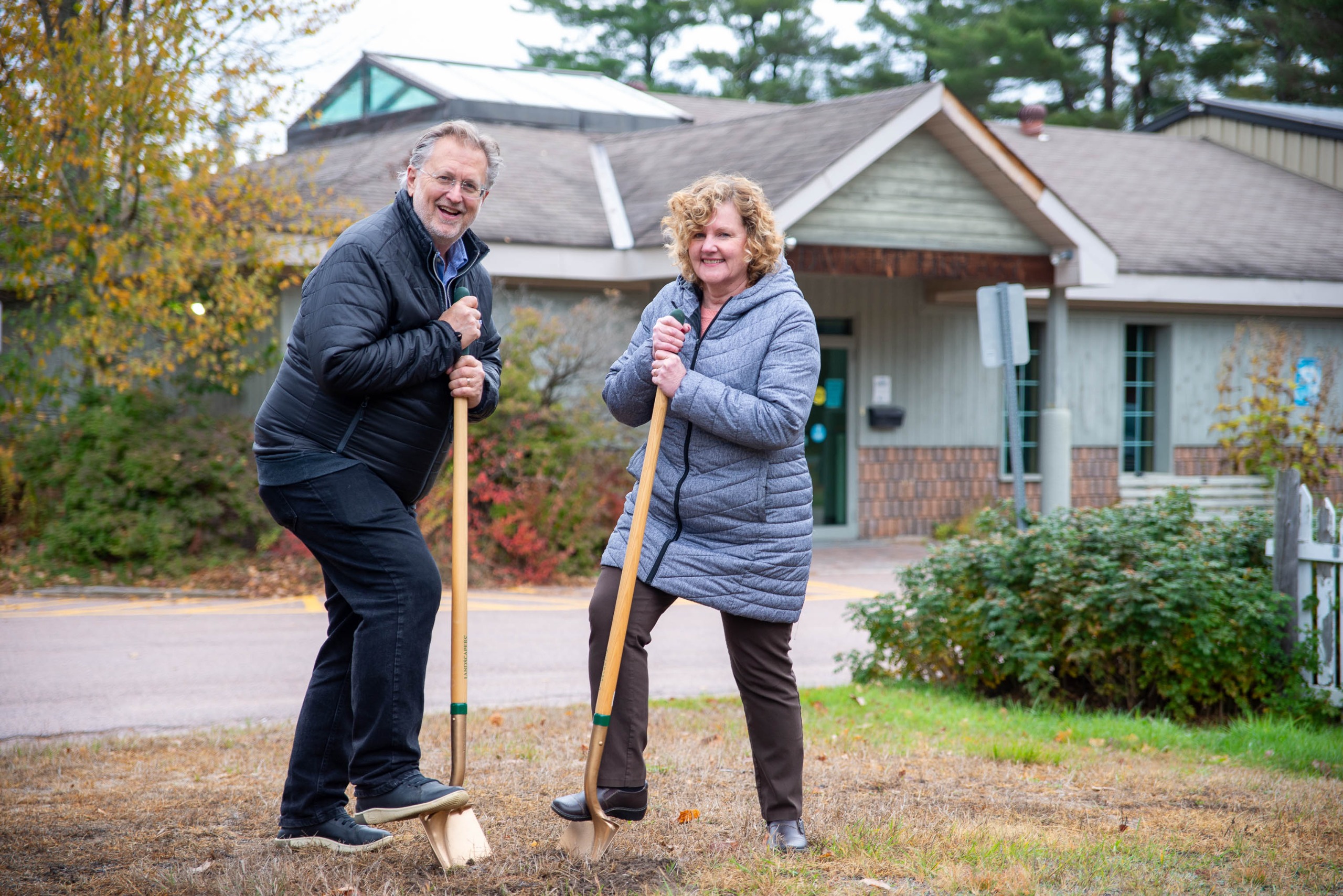 From right to left: Lake of Bays Library Board Chair Cathy Vanclieaf and Mayor Terry Glover turning sod...
